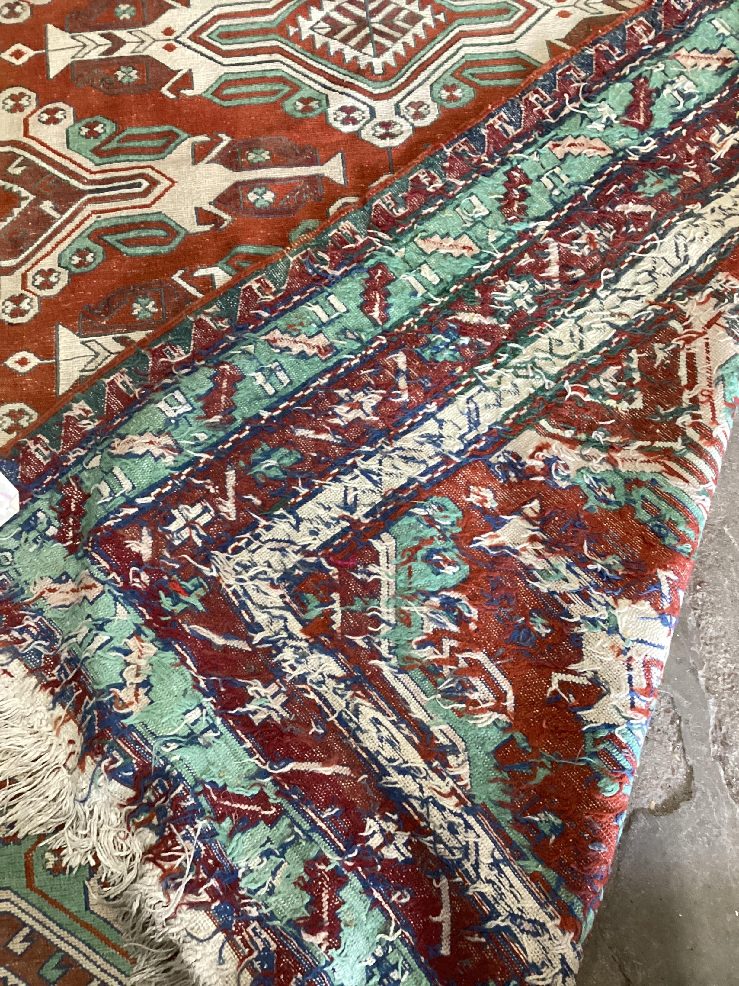 A Caucasian style red ground carpet, 260 x 180cm